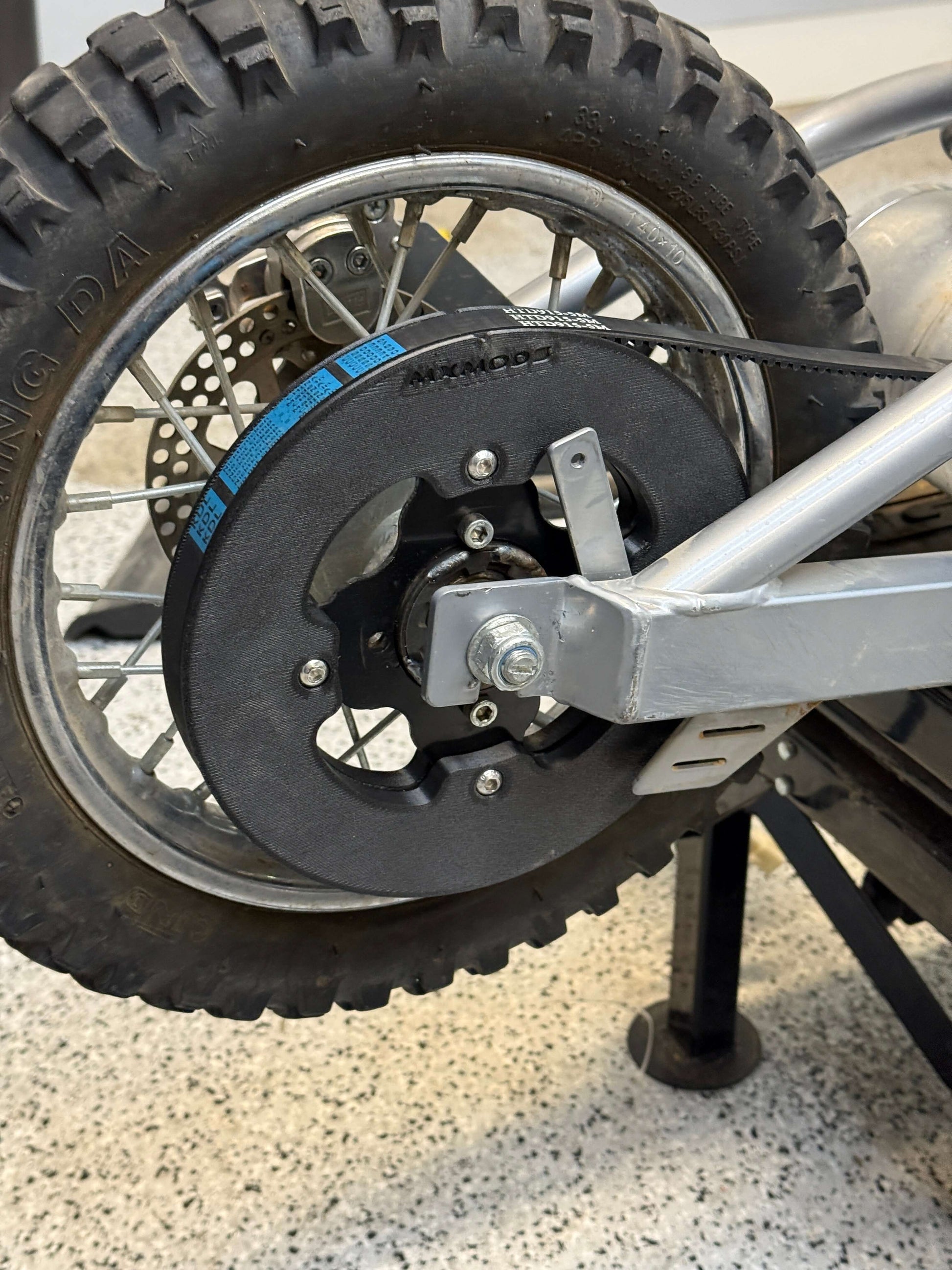 Close-up of a motorcycle wheel and mxmods belt rear sprocket on a Razor Mx650 dirt bike
